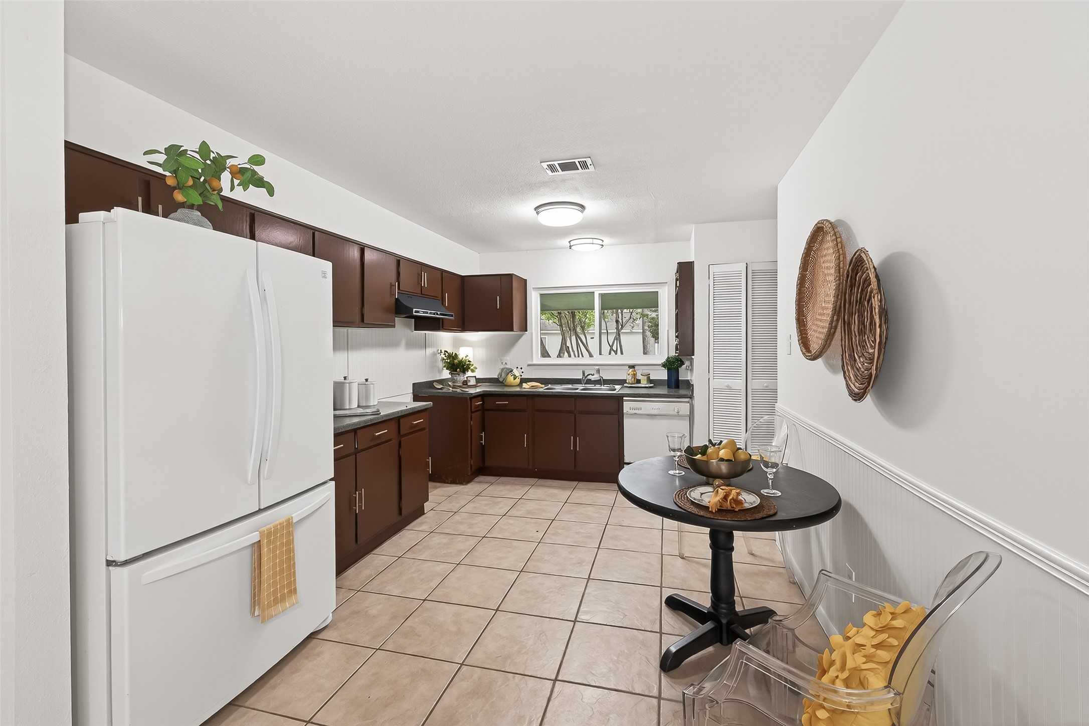 1 Laurel Oak Place Spring, TX 77380 - Photo 14 of 39 a kitchen with stainless steel appliances granite countertop a refrigerator a stove a sink dishwasher and a dining table with wooden floor
