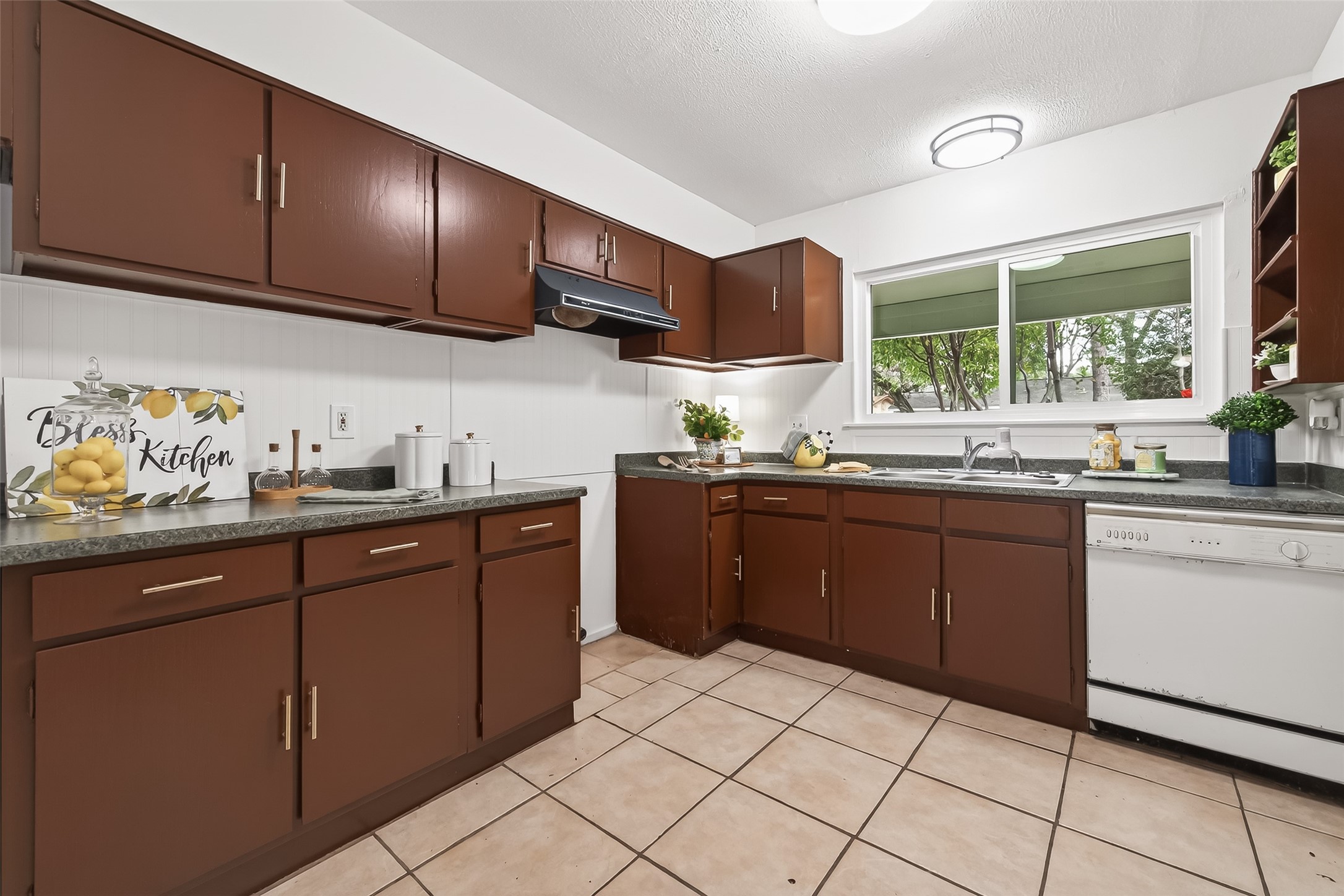 1 Laurel Oak Place Spring, TX 77380 - Photo 17 of 39 a kitchen with a sink window and cabinets