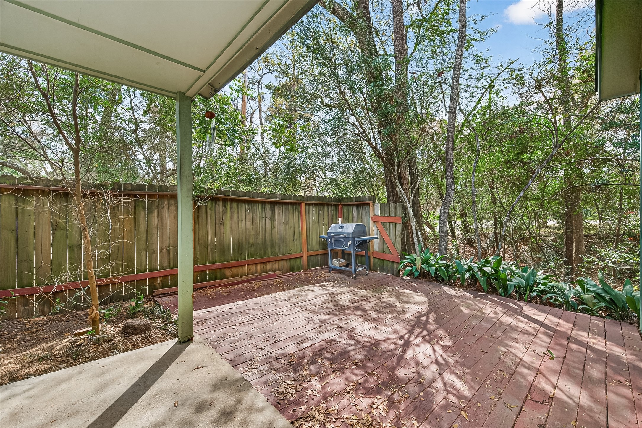 1 Laurel Oak Place Spring, TX 77380 - Photo 35 of 39 a view of a lake with a bench and trees in the patio