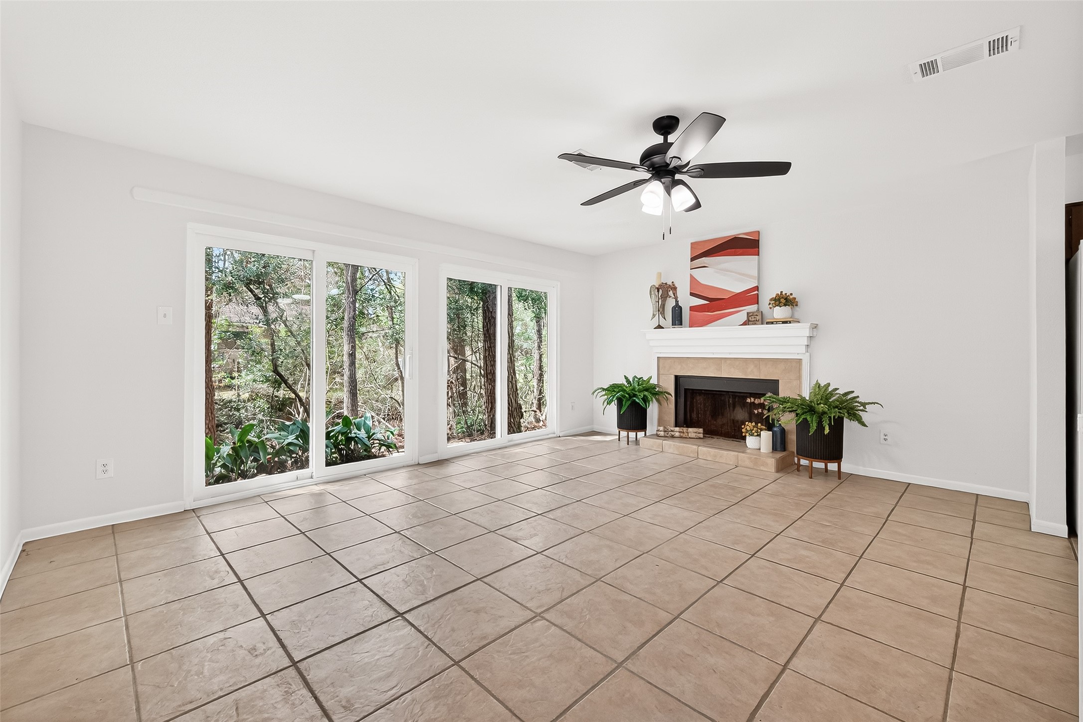 1 Laurel Oak Place Spring, TX 77380 - Photo 7 of 39 a view of an empty room with a fireplace and a window