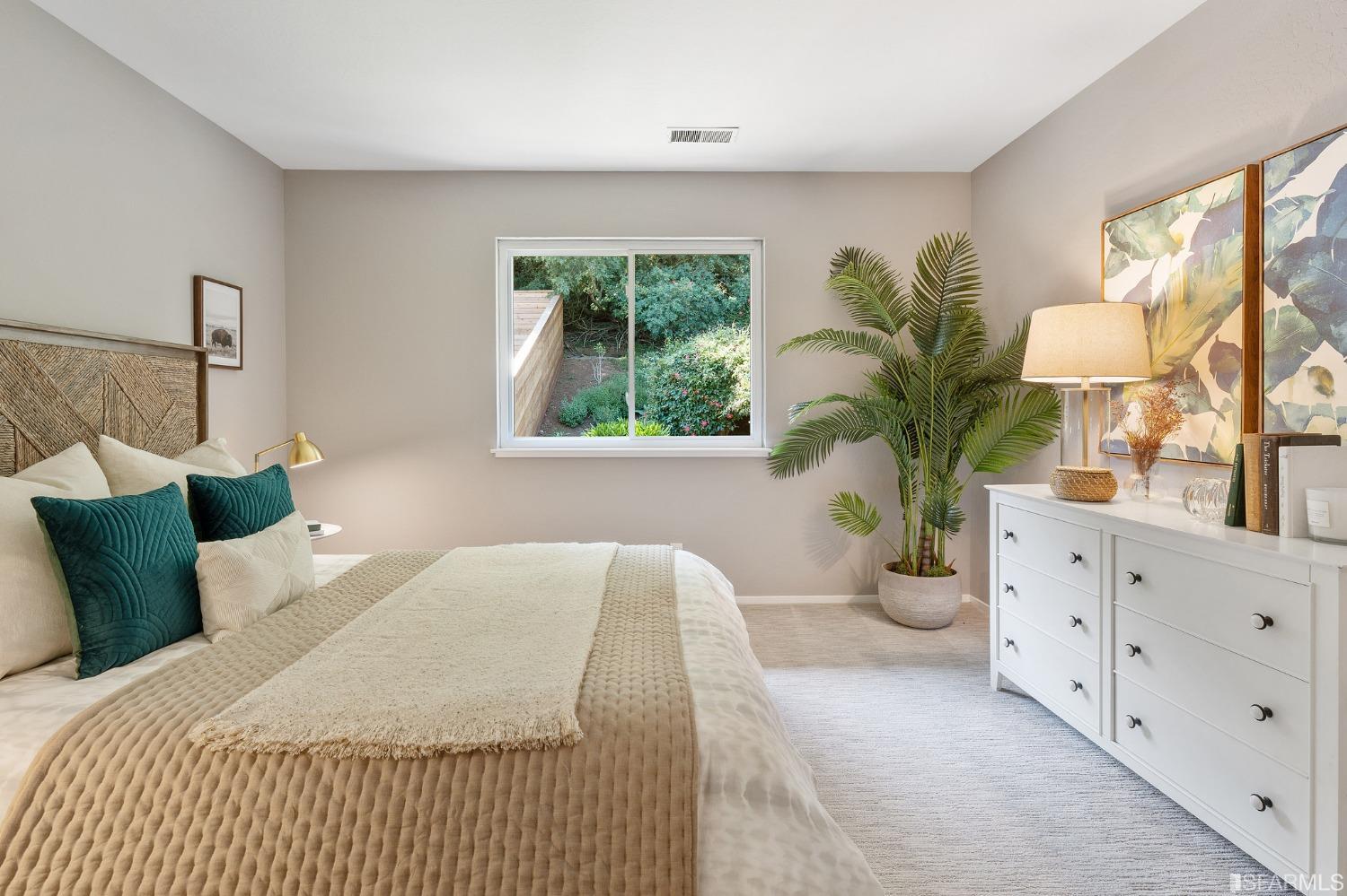 47 Malta Drive San Francisco, CA 94131 - Photo 26 of 40 a bedroom with a large bed and a potted plant