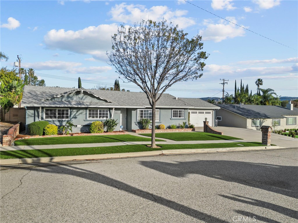 3042 Austin Avenue Simi Valley, CA 93063 - Photo 1 of 1 a view of a house next to a big yard and large trees