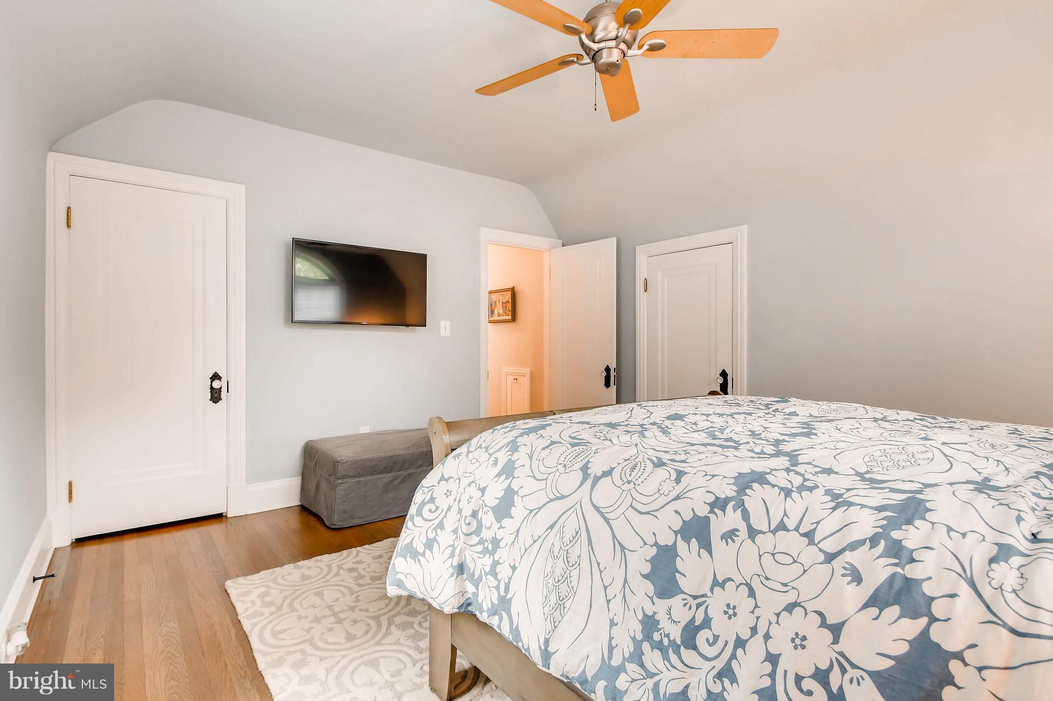 204 Witherspoon Road Baltimore, MD 21212 - Photo 22 of 30 a bedroom with a bed and a flat screen tv