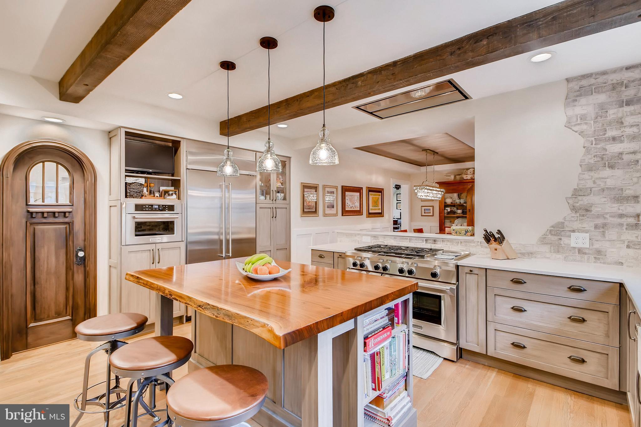 204 Witherspoon Road Baltimore, MD 21212 - Photo 5 of 30 a kitchen with a stove a refrigerator and a dining table