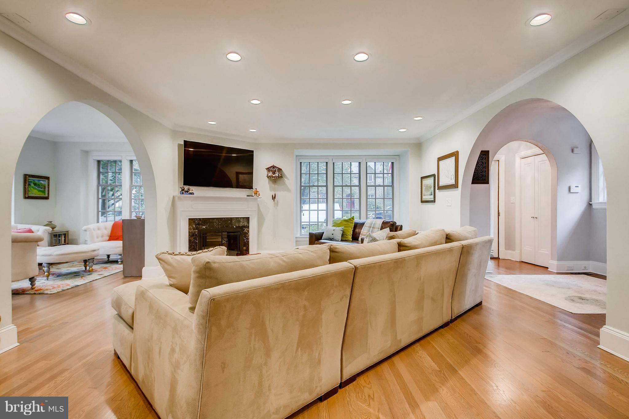 204 Witherspoon Road Baltimore, MD 21212 - Photo 10 of 30 a living room with furniture a fireplace and a flat screen tv