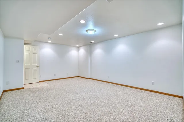 an empty room with a projector and screen