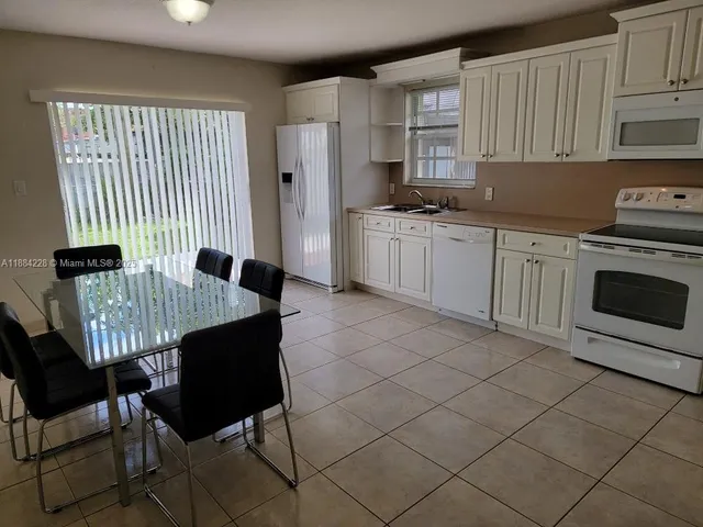 a kitchen with a stove a sink and a refrigerator