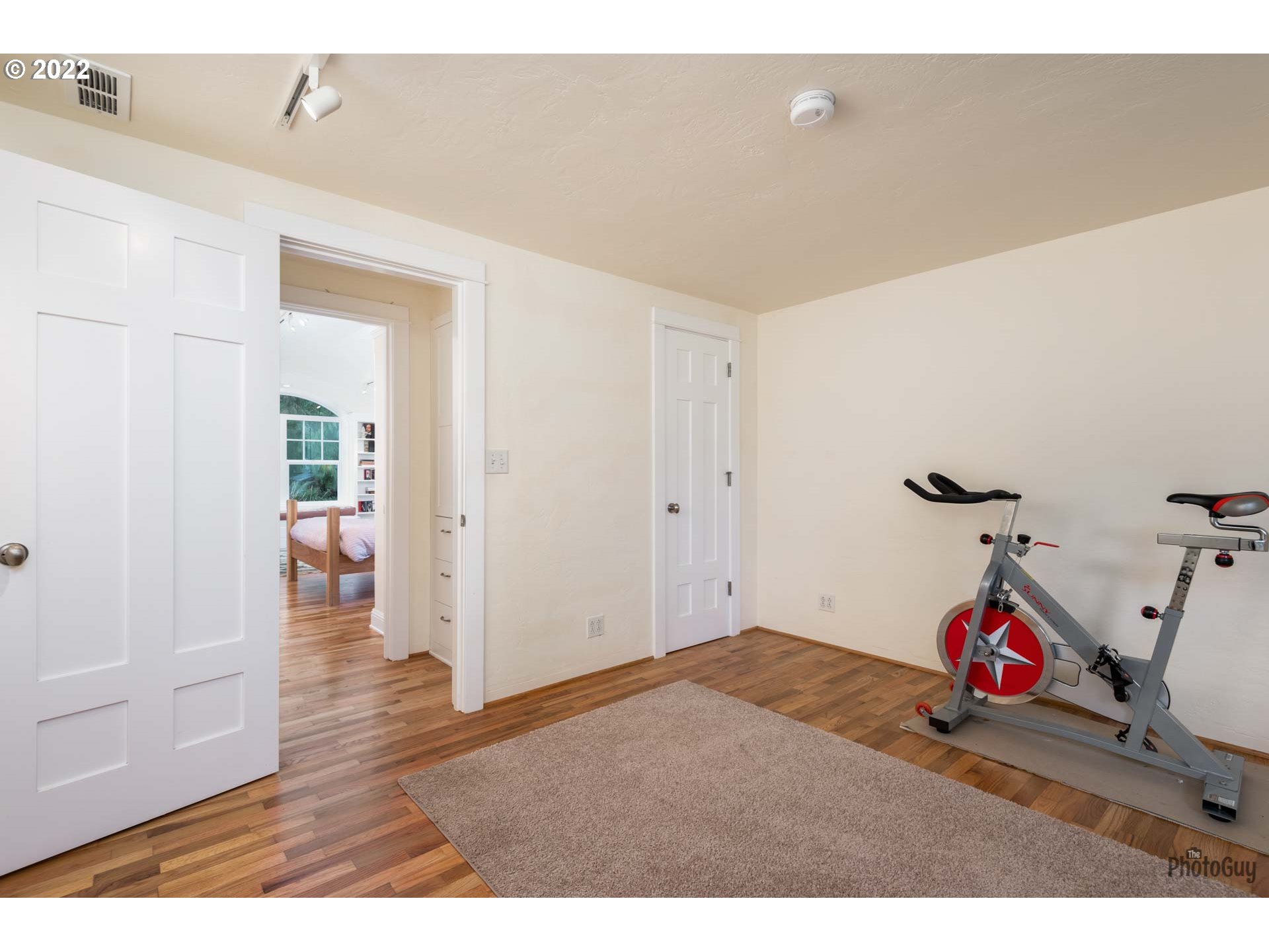 2027 Monterey Lane Eugene, OR 97401 - Photo 23 of 32 a bedroom with furniture and wooden floor