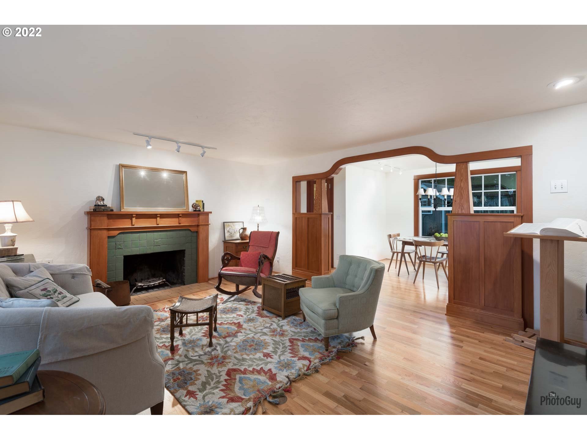 2027 Monterey Lane Eugene, OR 97401 - Photo 3 of 32 a living room with furniture a fireplace and a dining table with wooden floor