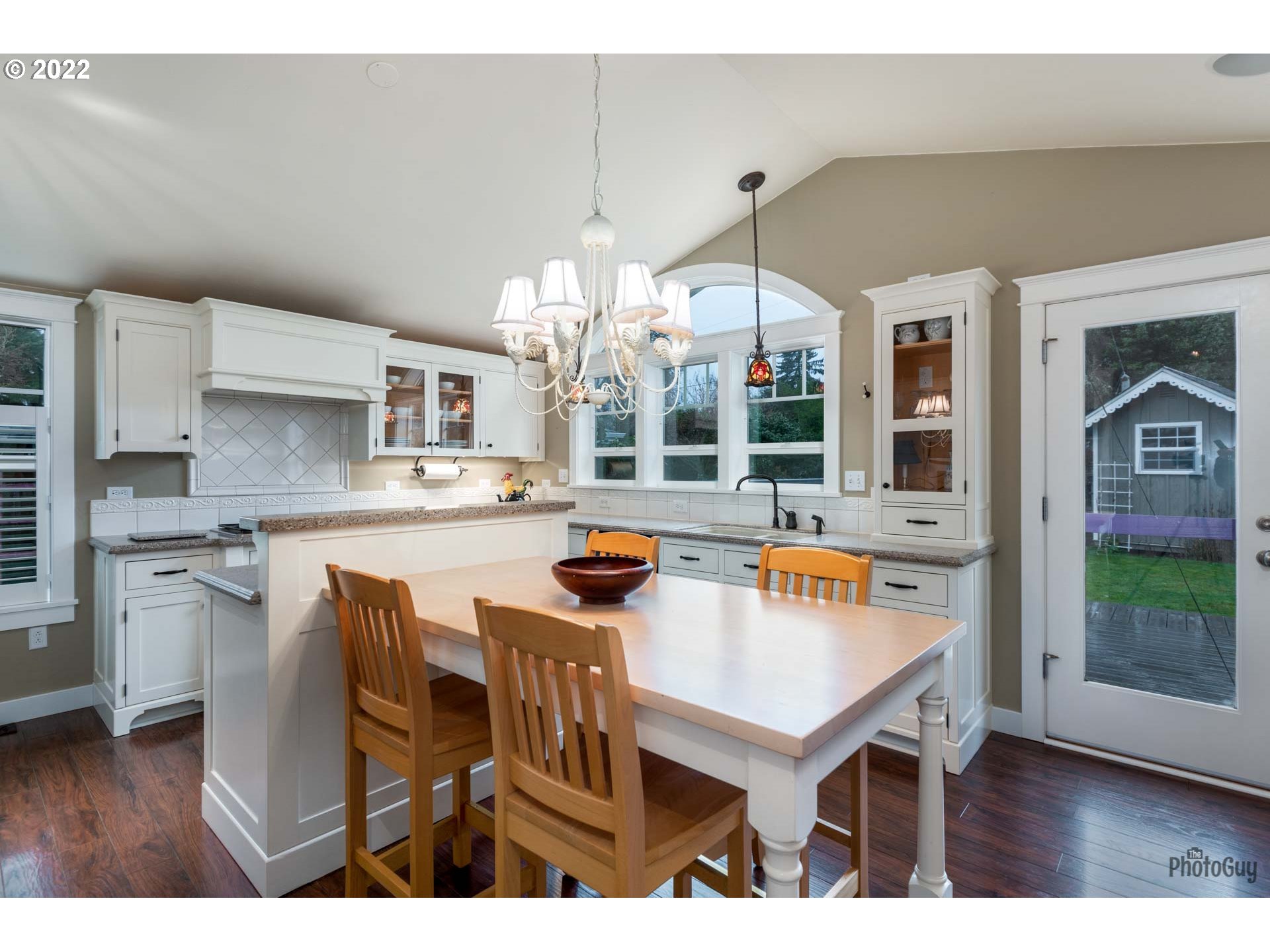 2027 Monterey Lane Eugene, OR 97401 - Photo 8 of 32 a open kitchen with stainless steel appliances kitchen island granite countertop a table chairs and a refrigerator
