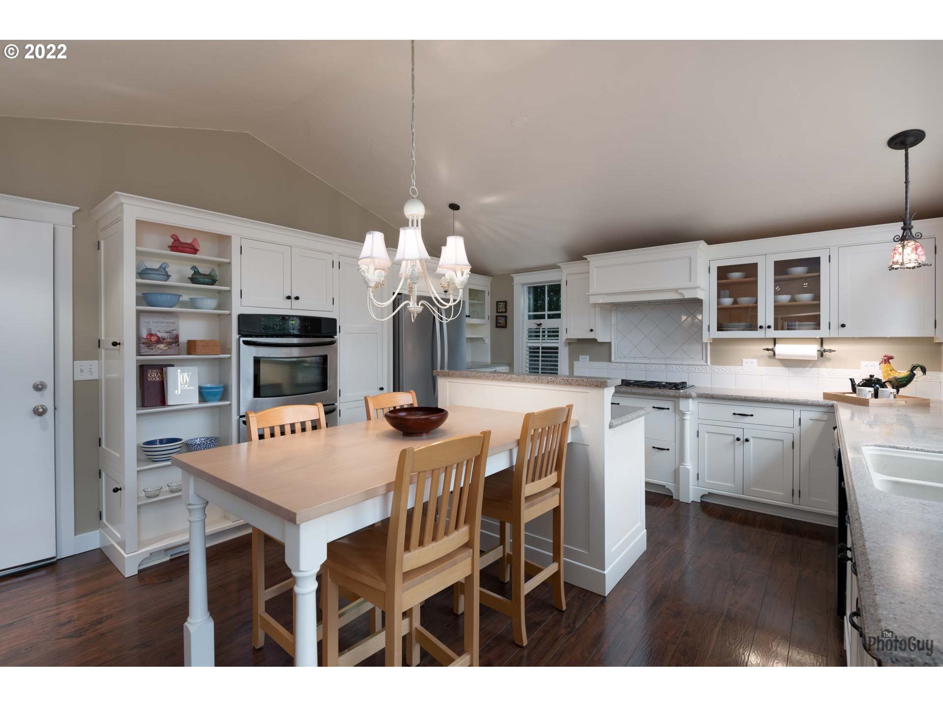2027 Monterey Lane Eugene, OR 97401 - Photo 10 of 32 a kitchen with stainless steel appliances kitchen island granite countertop a table chairs and a refrigerator