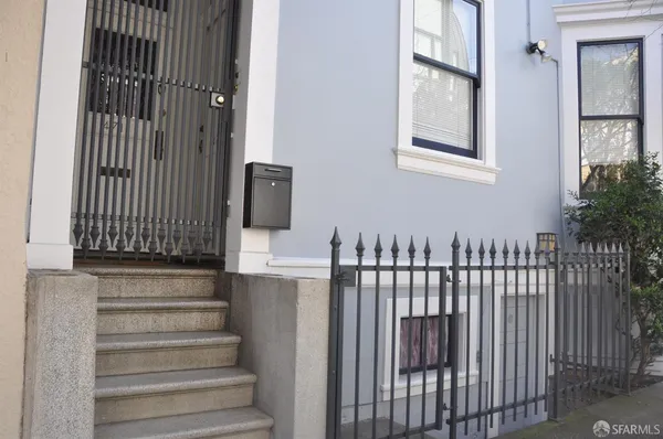 a view of staircase with white walls and railing