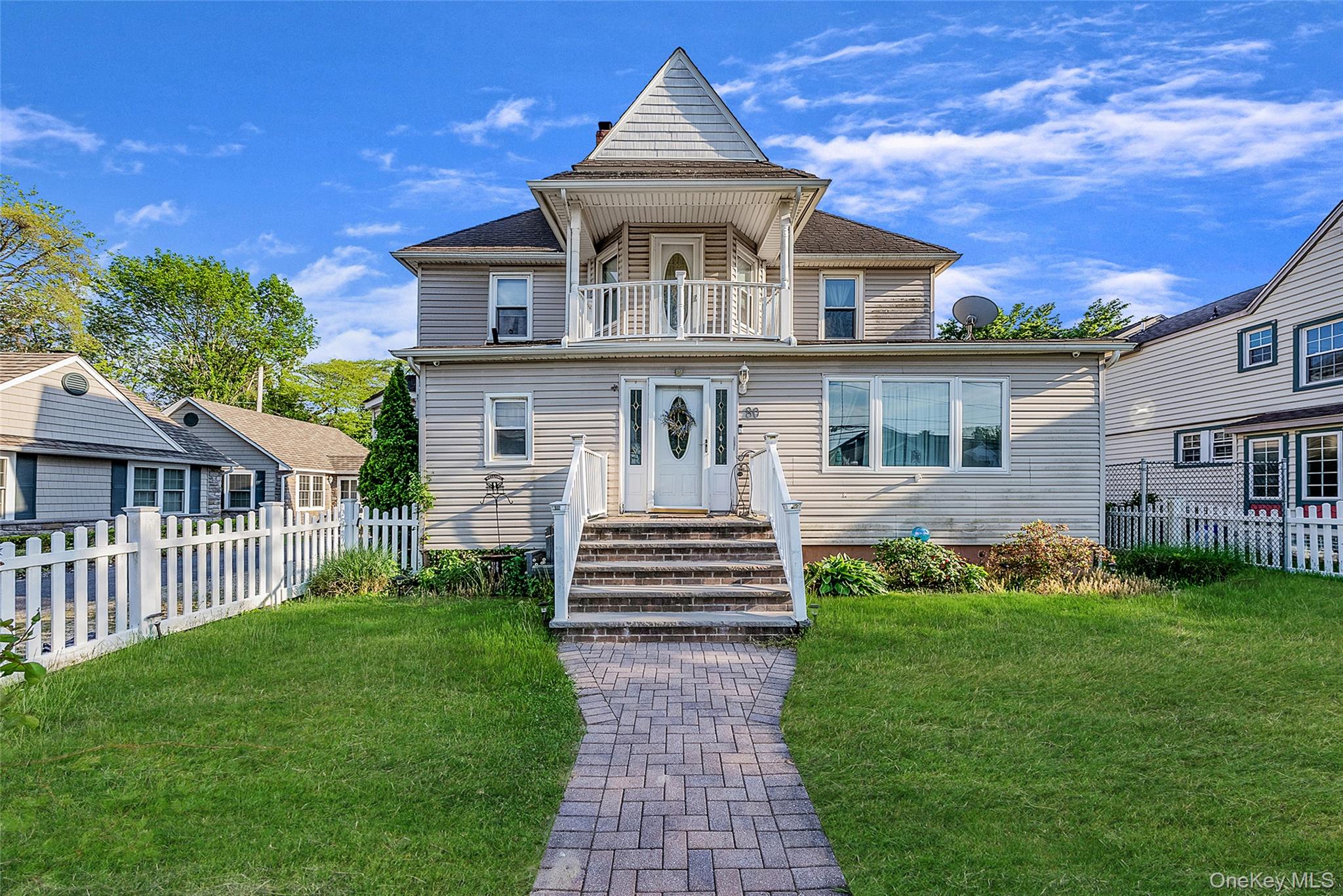80 George Street Babylon, NY 11702 - Photo 1 of 41 a front view of a house with garden and trees