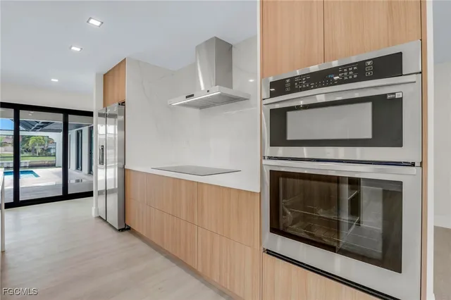 a kitchen with granite countertop a stove and a microwave