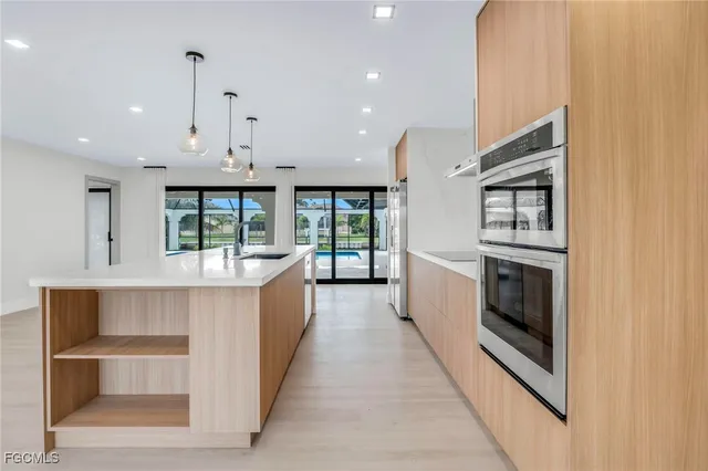 a large white kitchen with a large window
