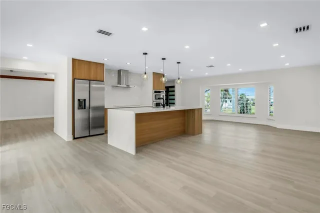 a view of a kitchen with a sink and a refrigerator