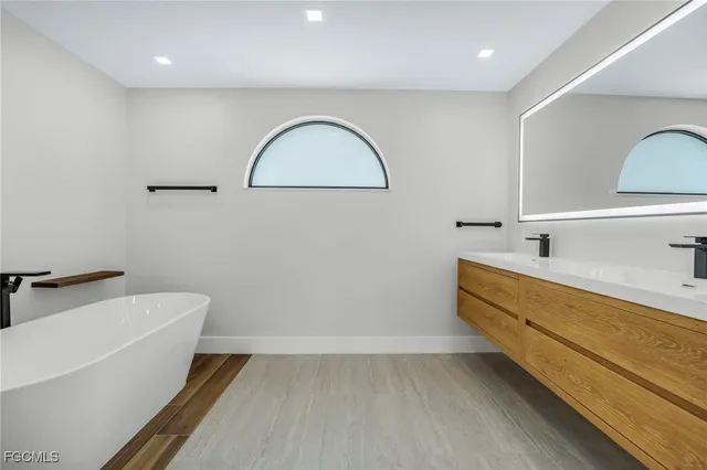a bathroom with a bathtub and a sink