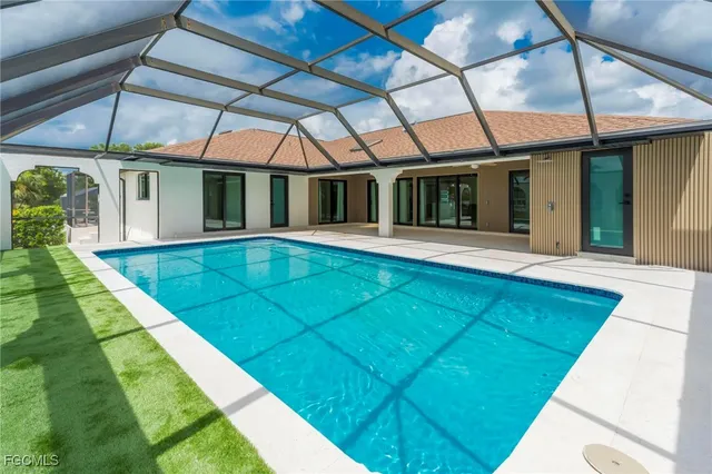 a view of a patio with a table and chairs under an umbrella