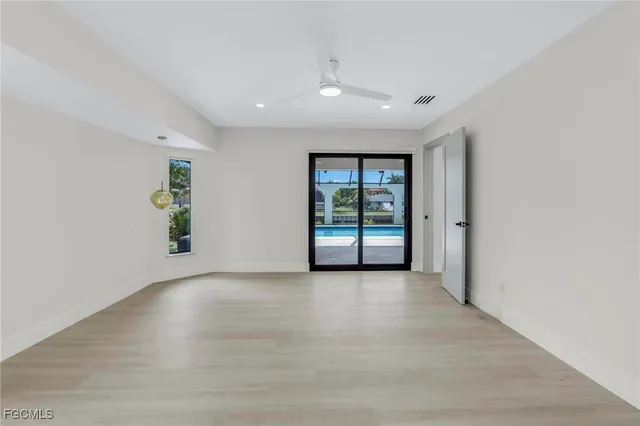 an empty room with windows and closet
