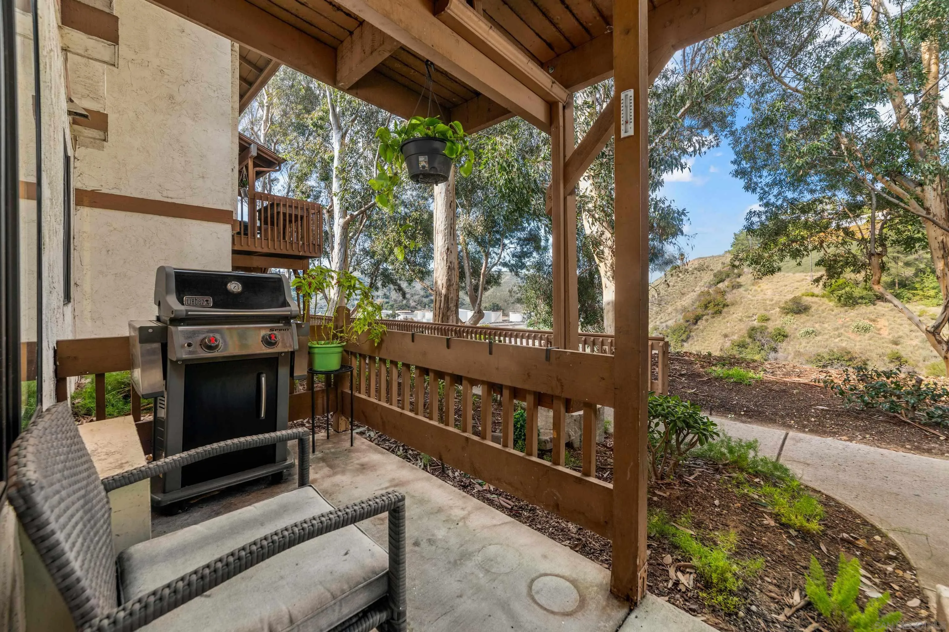 6370 Rancho Mission Road, Unit 913 San Diego, CA 92108 - Photo 17 of 30 a view of a porch with furniture and a yard