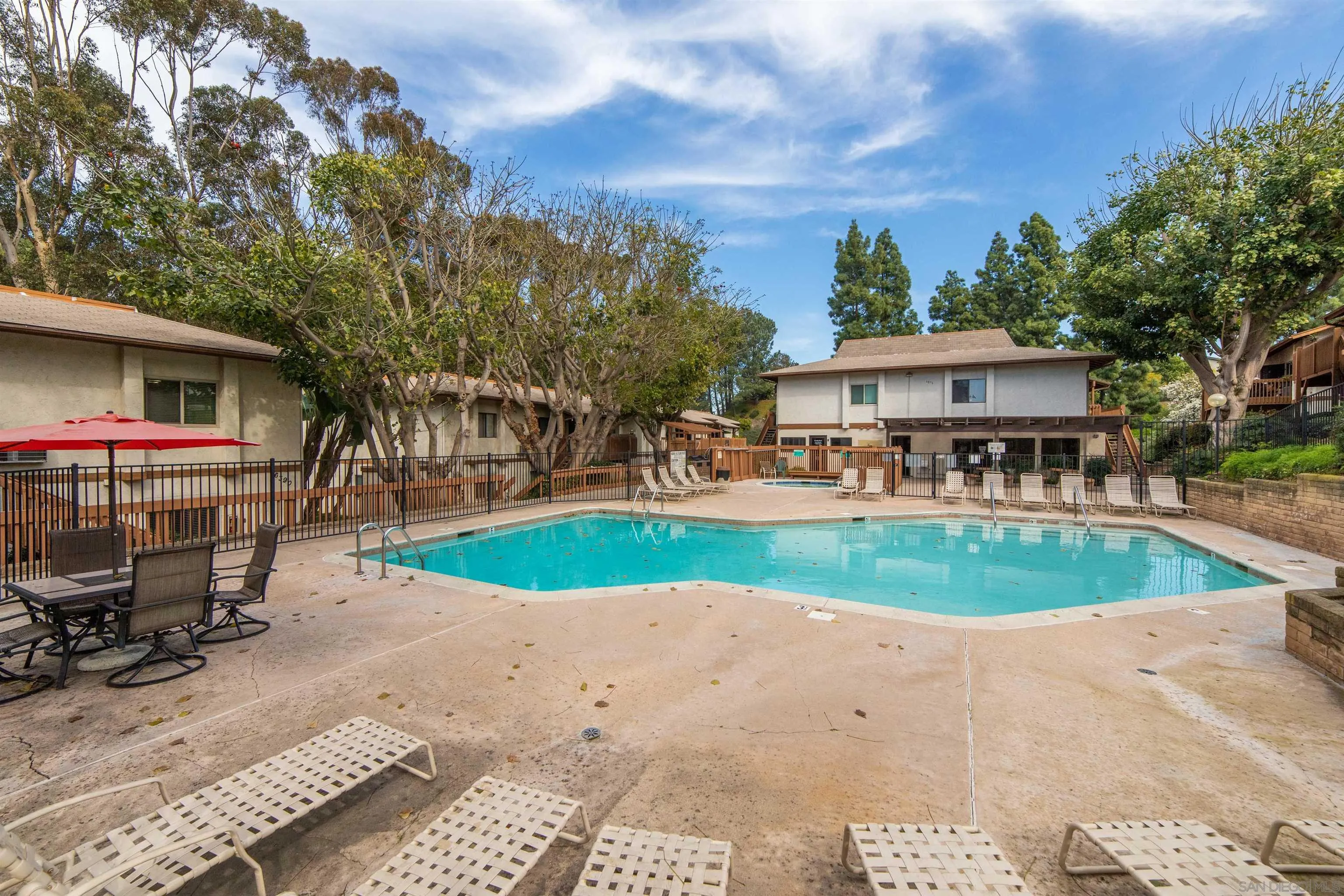 6370 Rancho Mission Road, Unit 913 San Diego, CA 92108 - Photo 20 of 30 a view of a house with a swimming pool and sitting area