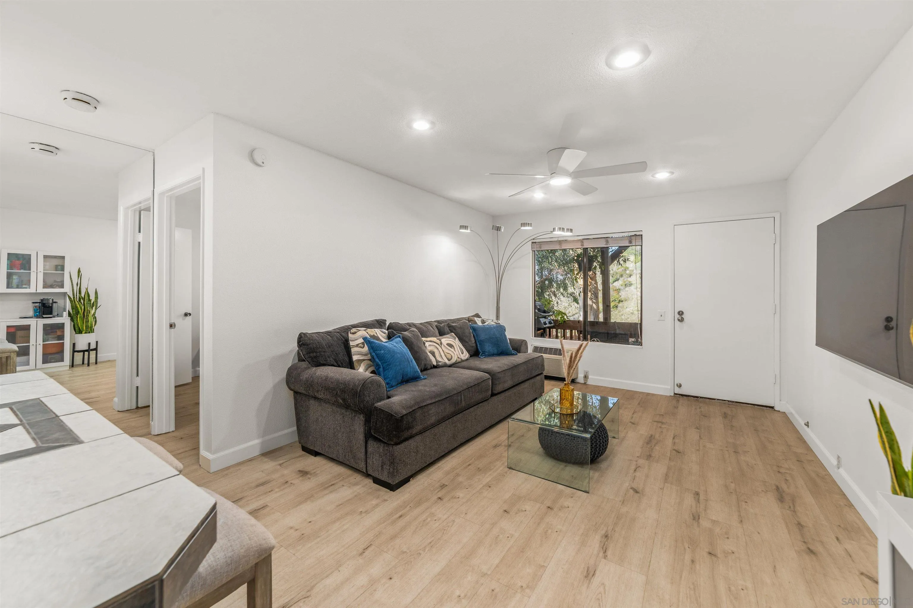 6370 Rancho Mission Road, Unit 913 San Diego, CA 92108 - Photo 8 of 30 a living room with furniture a window and wooden floor