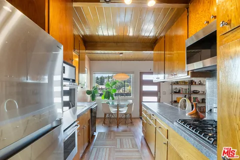 a kitchen with lots of counter top space and stainless steel appliances