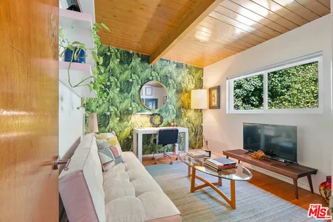 a living room with furniture fireplace and flat screen tv