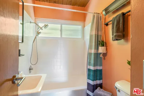 a bathroom with a shower and a tub