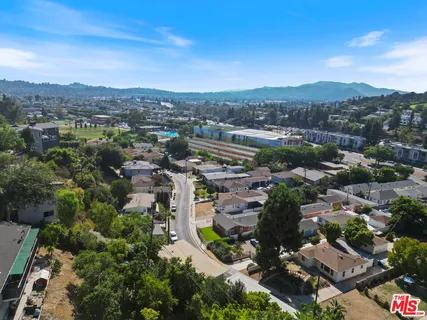 an aerial view of a house with a yard and garden