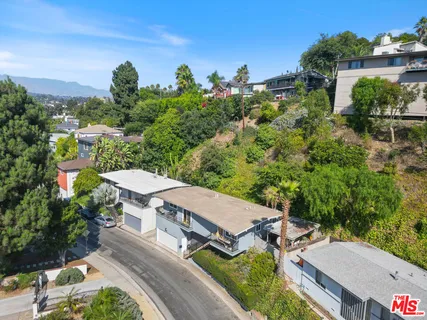 an aerial view of a house with yard swimming pool and outdoor seating