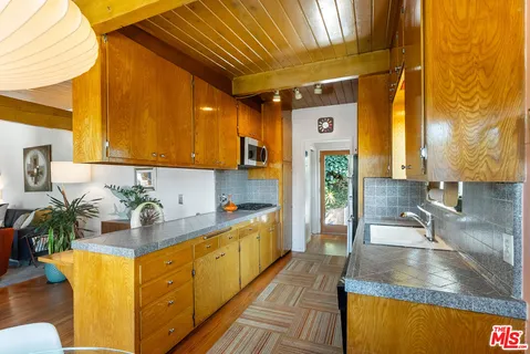 a kitchen with stainless steel appliances granite countertop a sink and a cabinets