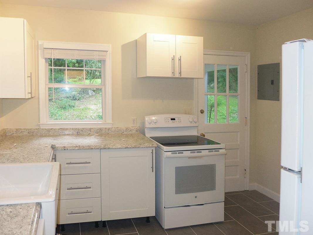 731 Raleigh Road Chapel Hill, NC 27514 - Photo 5 of 14 a kitchen with a stove and a sink