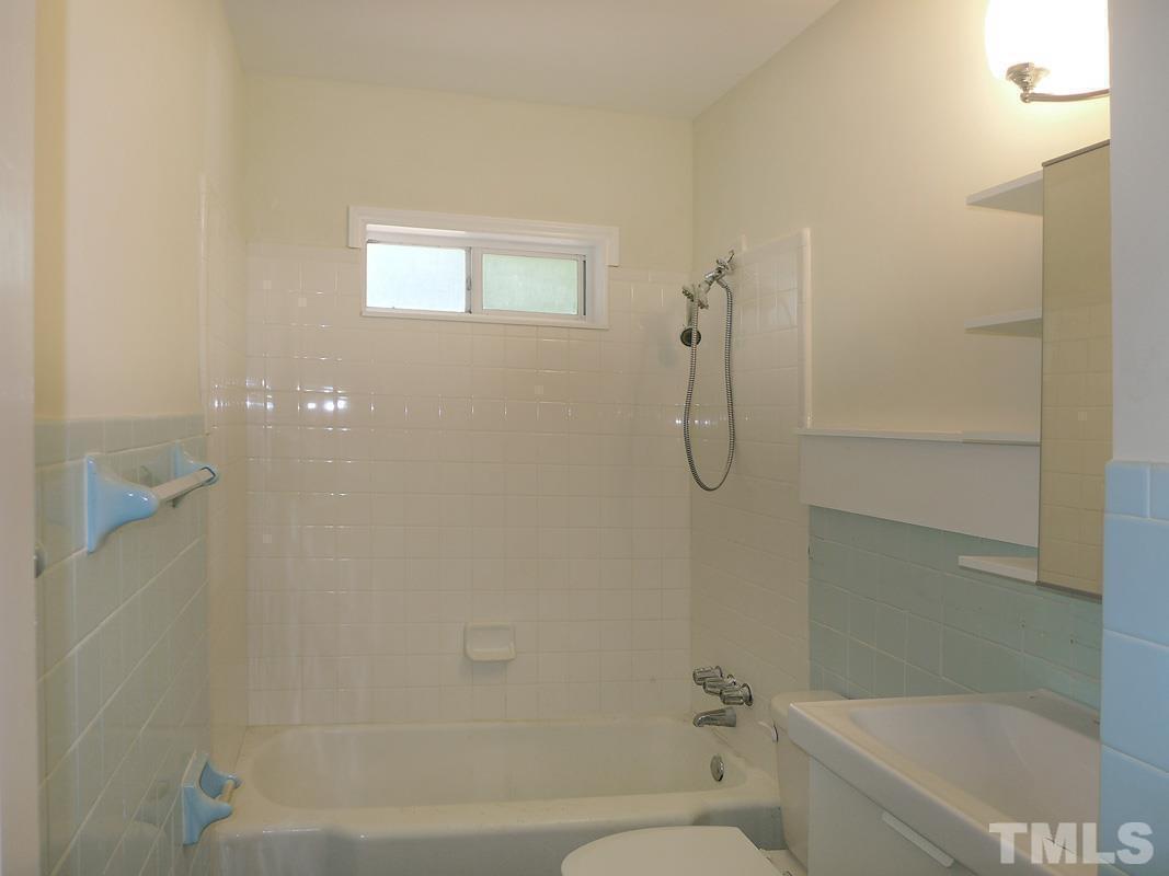 731 Raleigh Road Chapel Hill, NC 27514 - Photo 9 of 14 a bathroom with a shower and a toilet