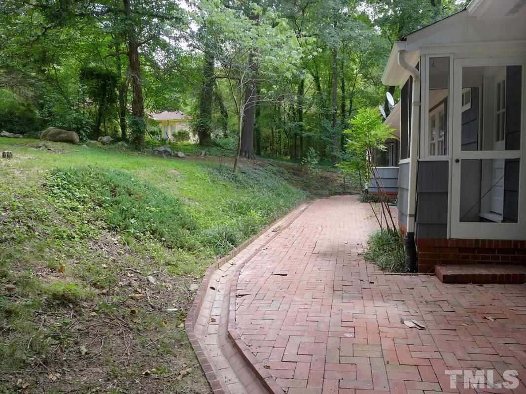 731 Raleigh Road Chapel Hill, NC 27514 - Photo 10 of 14 a view of a backyard with brick wall and plants