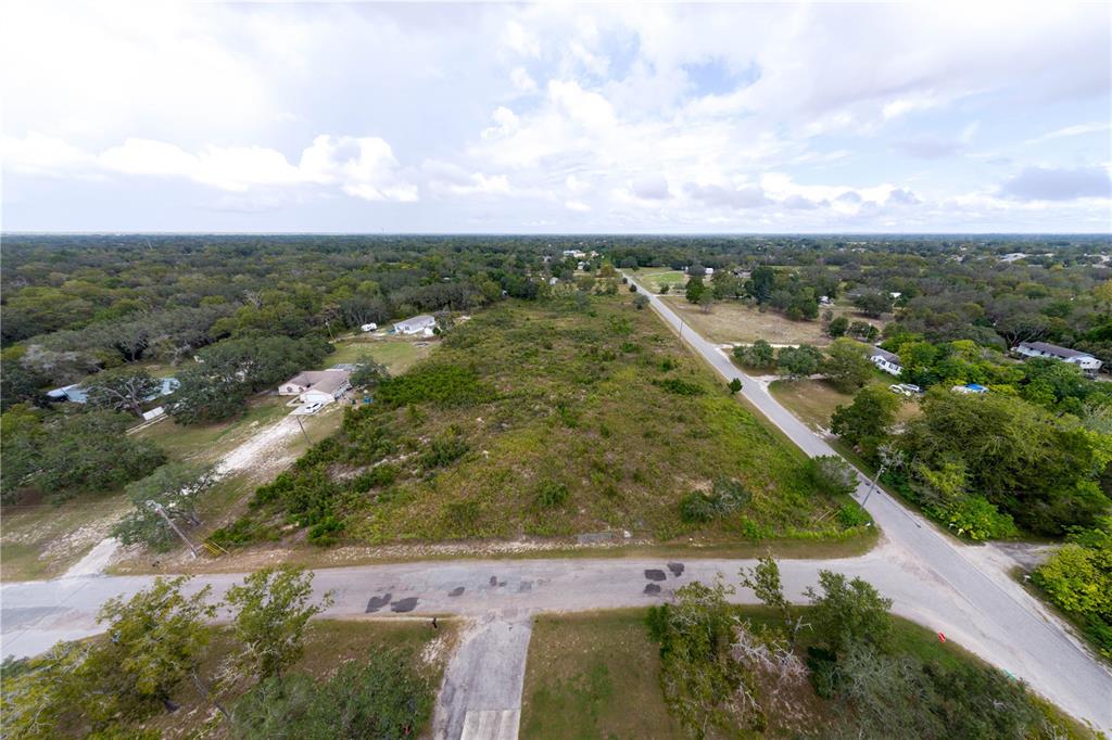 94 May Gold Lane Spring Hill, FL 34608 - Photo 2 of 7 an aerial view of residential houses with outdoor space and trees
