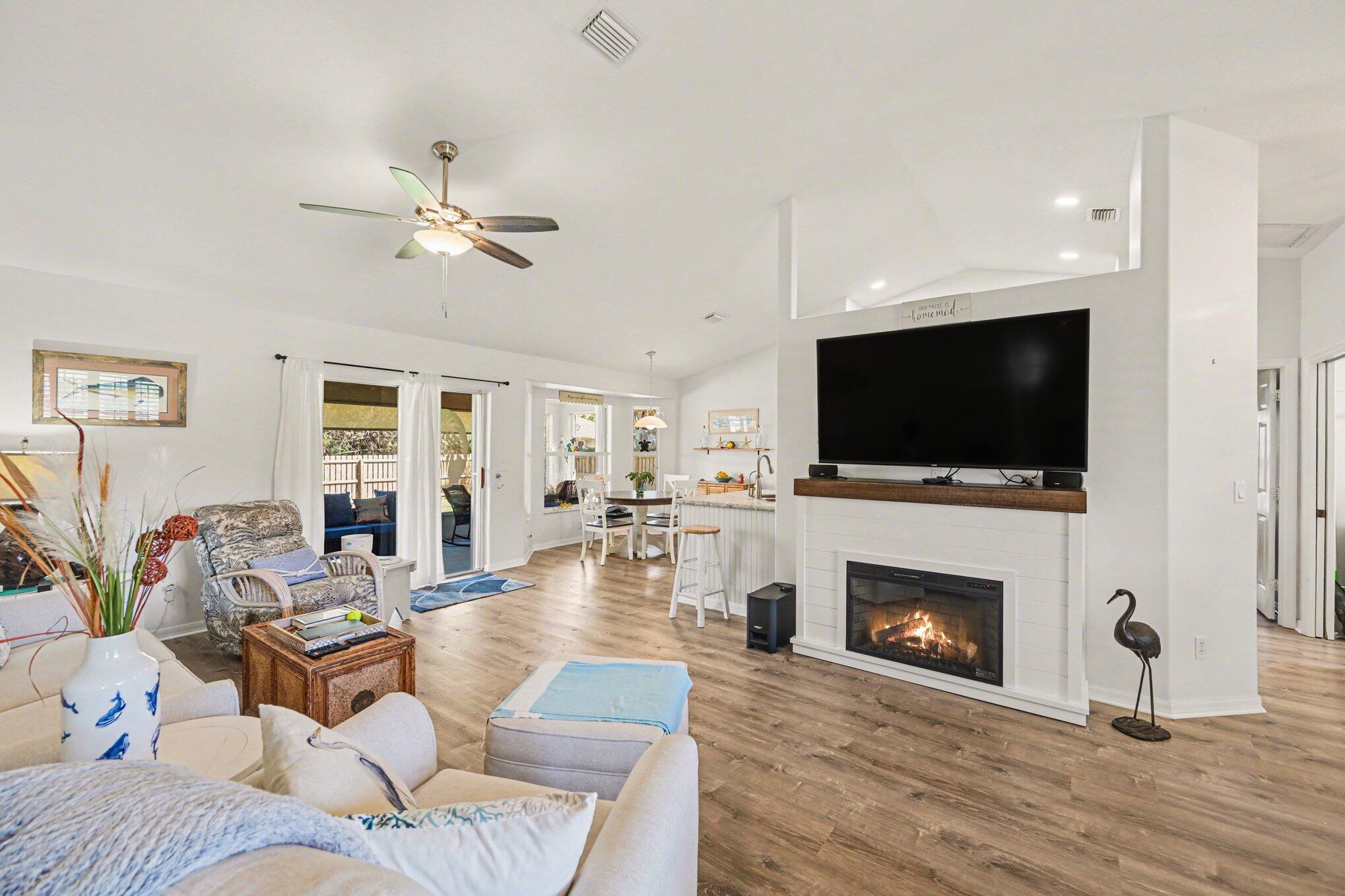 1362 Seahouse Street Sebastian, FL 32958 - Photo 12 of 28 a living room with furniture a flat screen tv and a fireplace