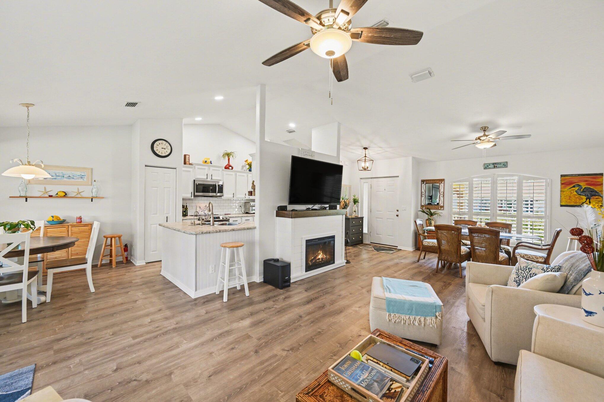 1362 Seahouse Street Sebastian, FL 32958 - Photo 13 of 28 a living room with furniture a flat screen tv and kitchen view