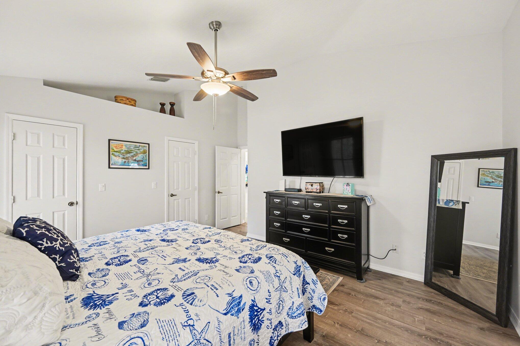 1362 Seahouse Street Sebastian, FL 32958 - Photo 16 of 28 a bedroom with a bed and a flat screen tv