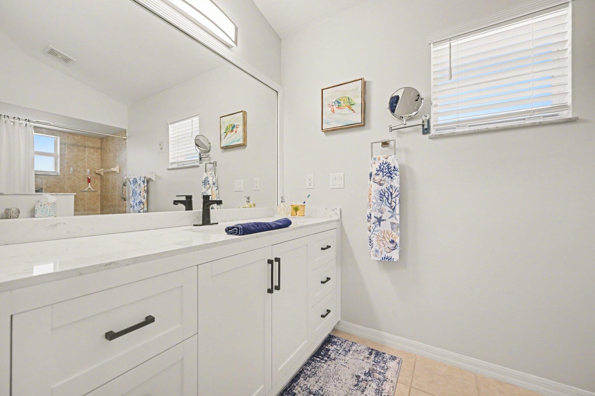 1362 Seahouse Street Sebastian, FL 32958 - Photo 17 of 28 a spacious bathroom with a sink and a mirror