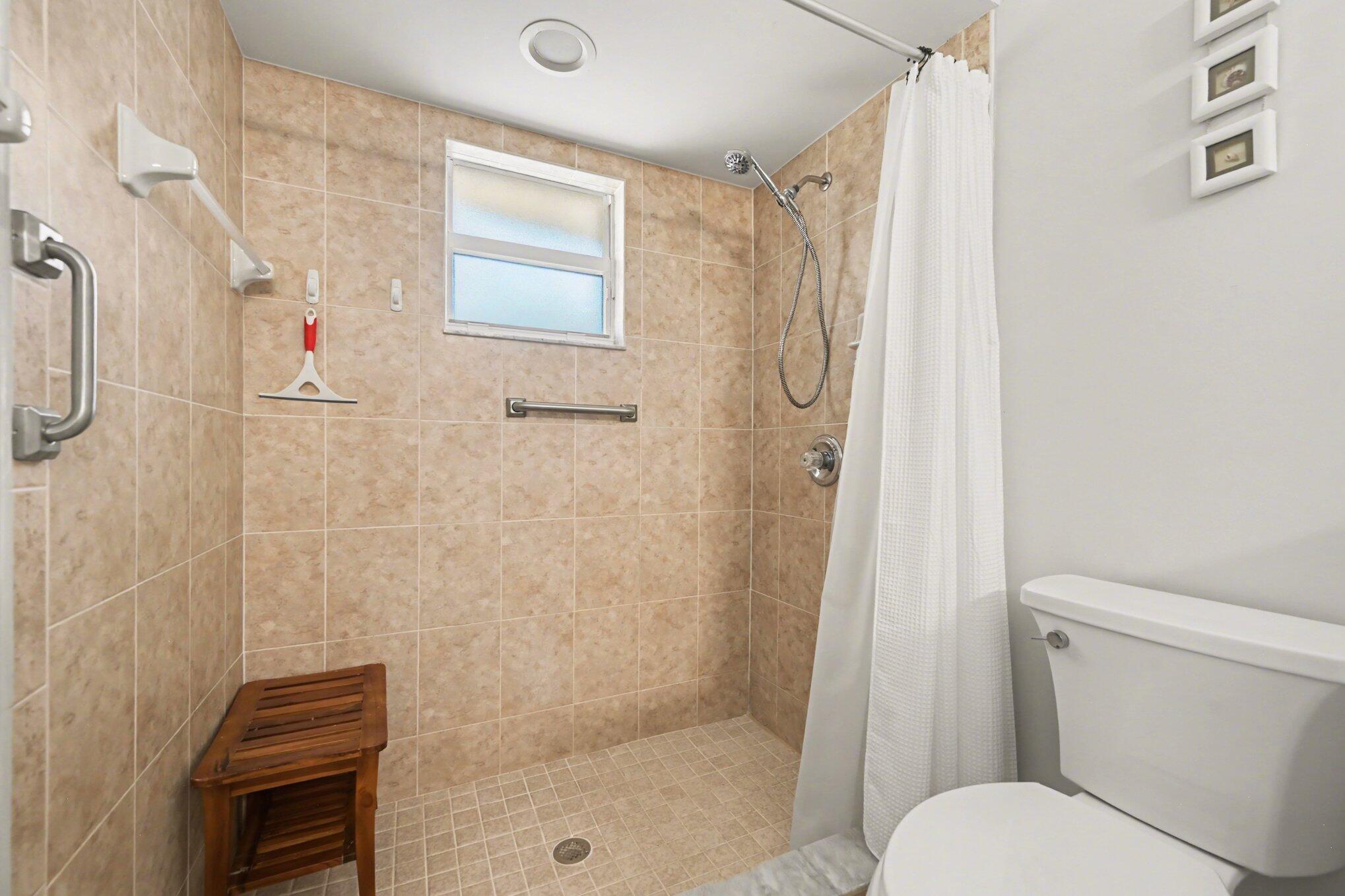 1362 Seahouse Street Sebastian, FL 32958 - Photo 18 of 28 a bathroom with a shower and a toilet