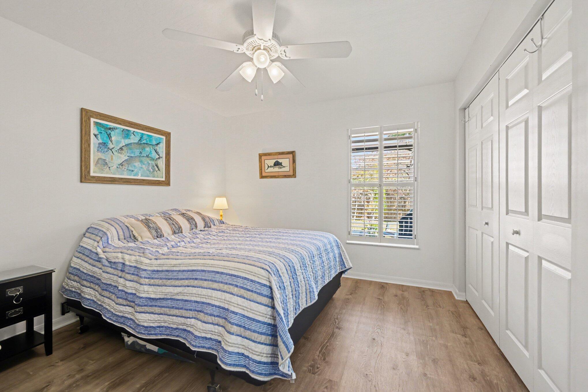 1362 Seahouse Street Sebastian, FL 32958 - Photo 19 of 28 a bedroom with a bed dresser and wooden floor
