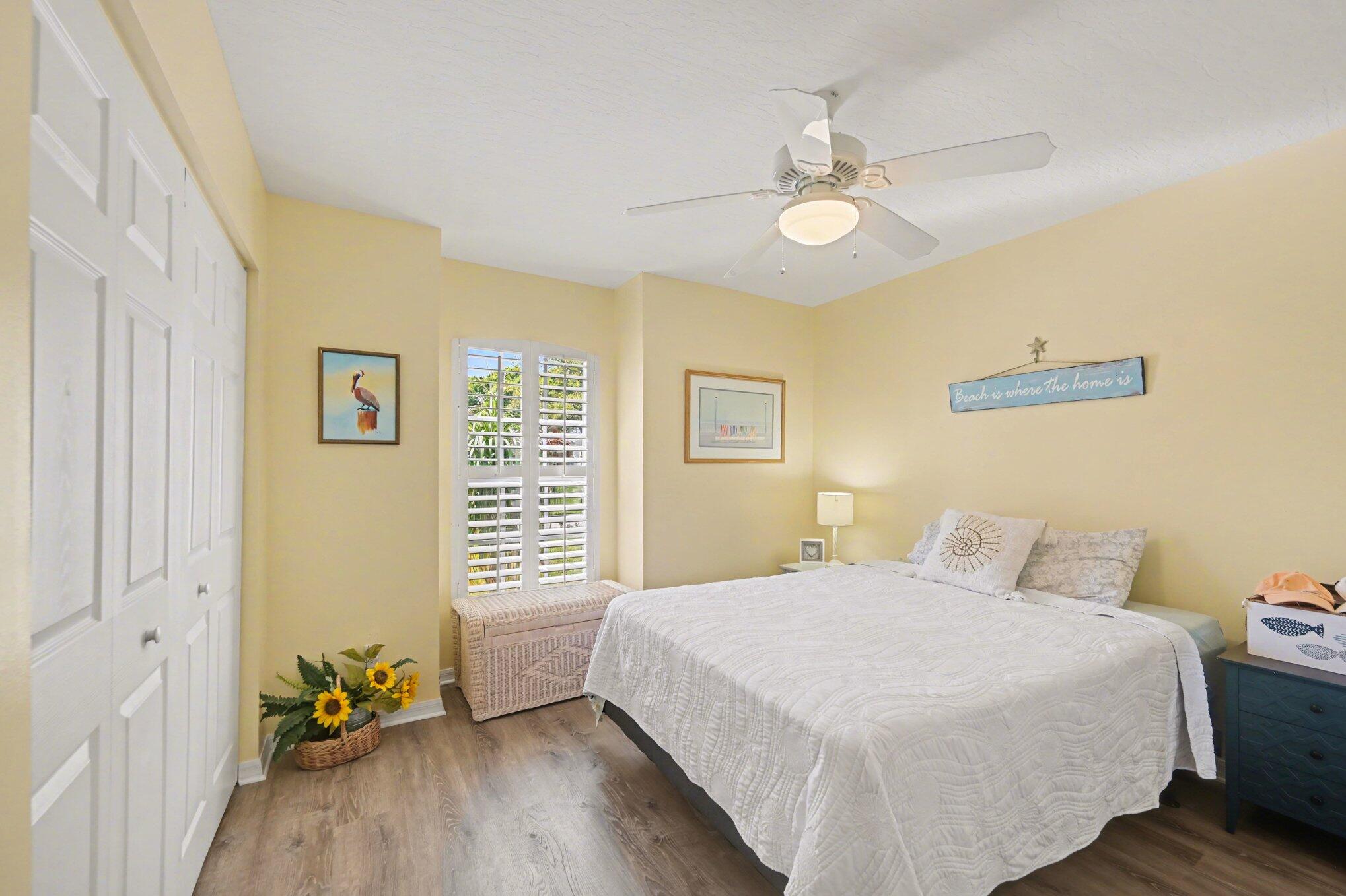 1362 Seahouse Street Sebastian, FL 32958 - Photo 20 of 28 a bedroom with a bed and a chandelier