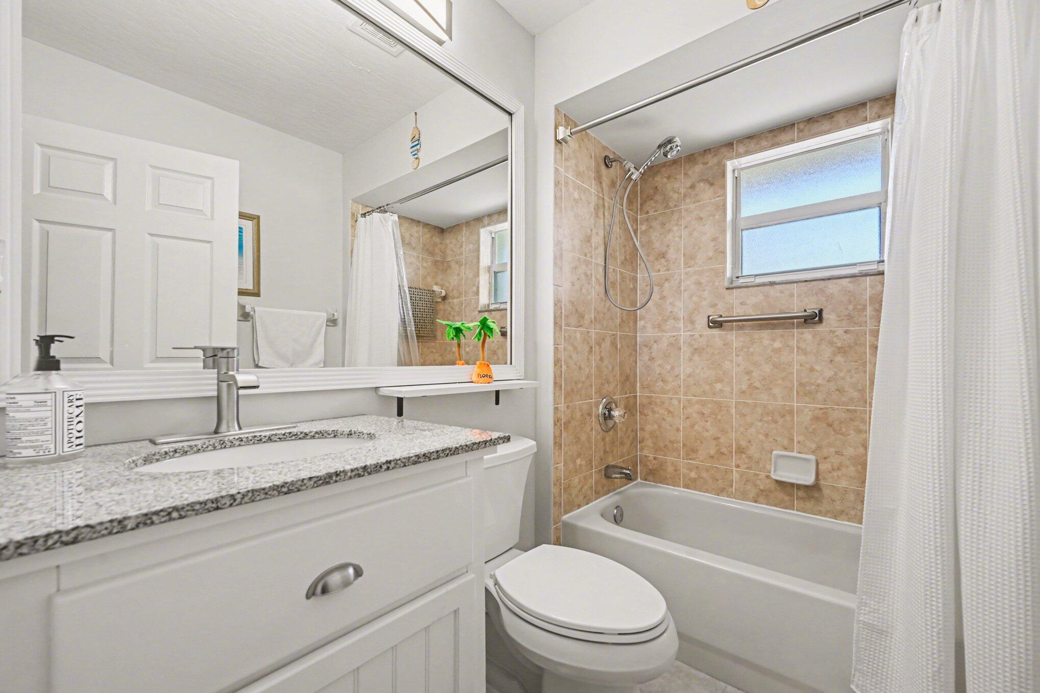 1362 Seahouse Street Sebastian, FL 32958 - Photo 21 of 28 a bathroom with a granite countertop sink toilet tub and shower