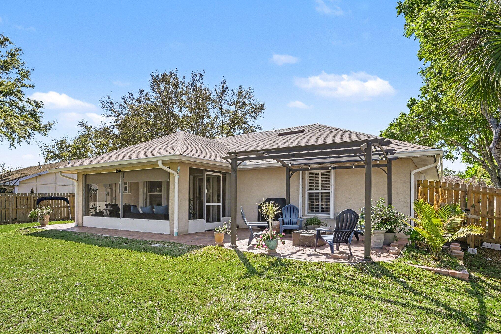 1362 Seahouse Street Sebastian, FL 32958 - Photo 26 of 28 a view of a house with backyard porch and sitting area