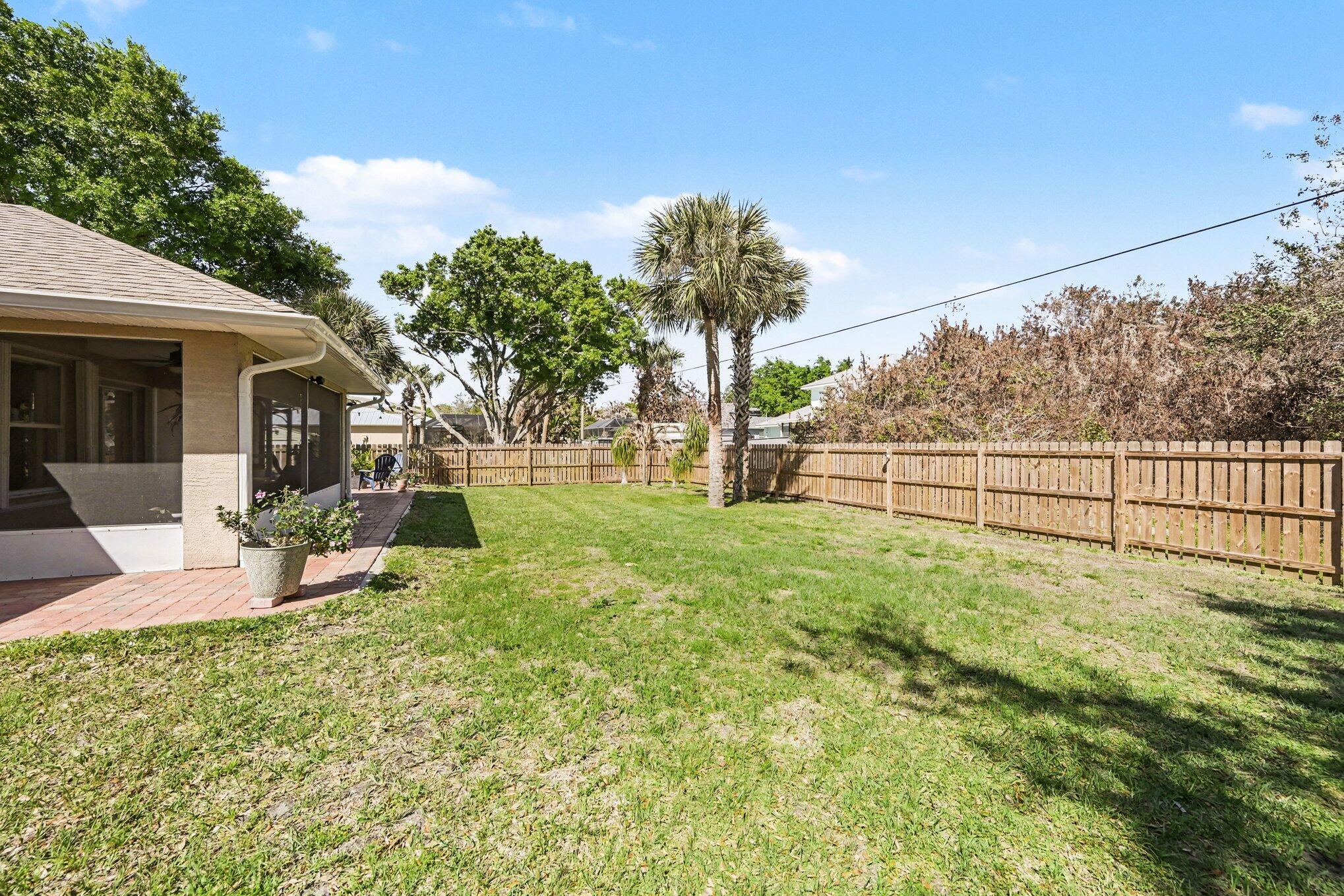 1362 Seahouse Street Sebastian, FL 32958 - Photo 28 of 28 a view of a garden with a bench