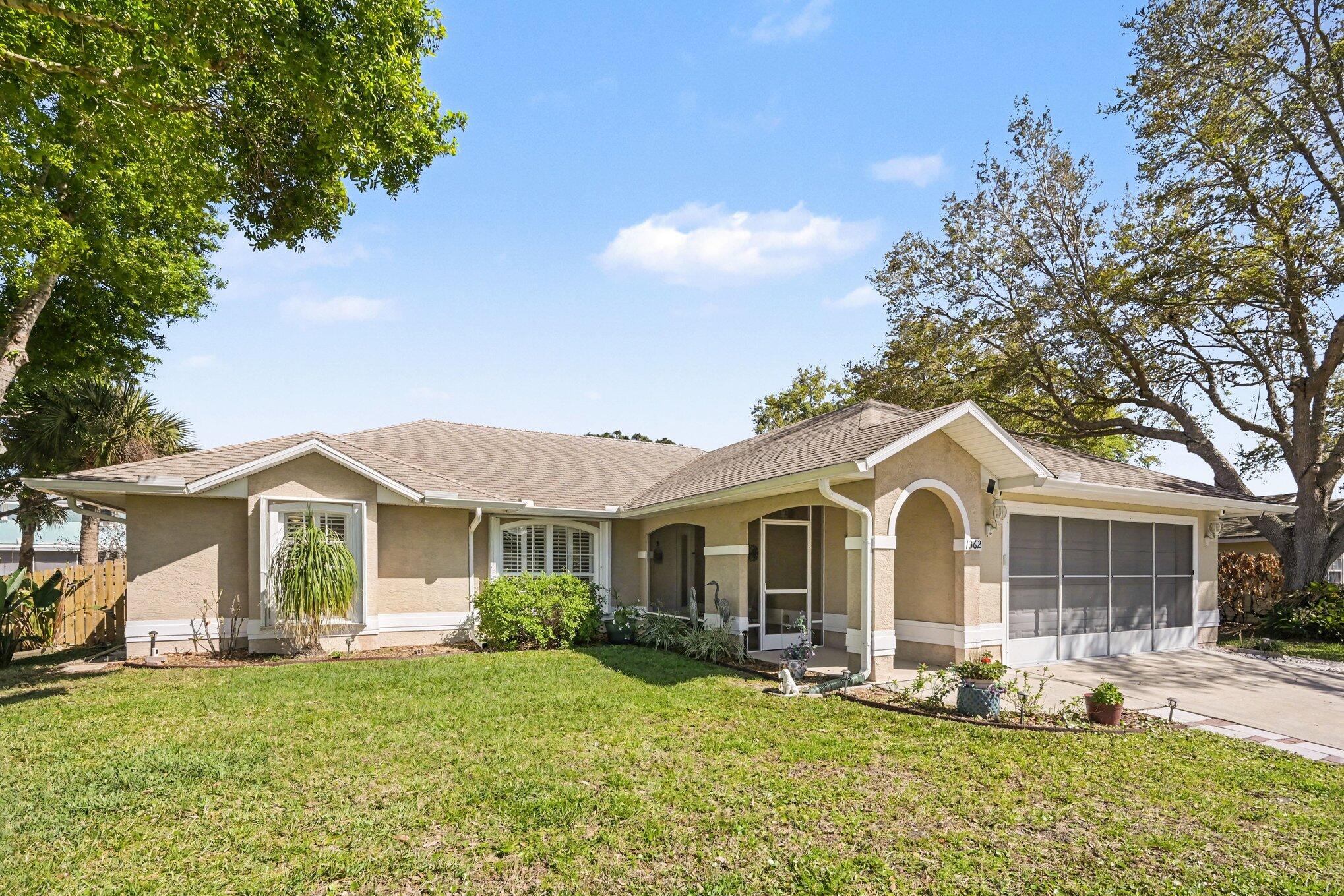 1362 Seahouse Street Sebastian, FL 32958 - Photo 4 of 28 a front view of a house with garden