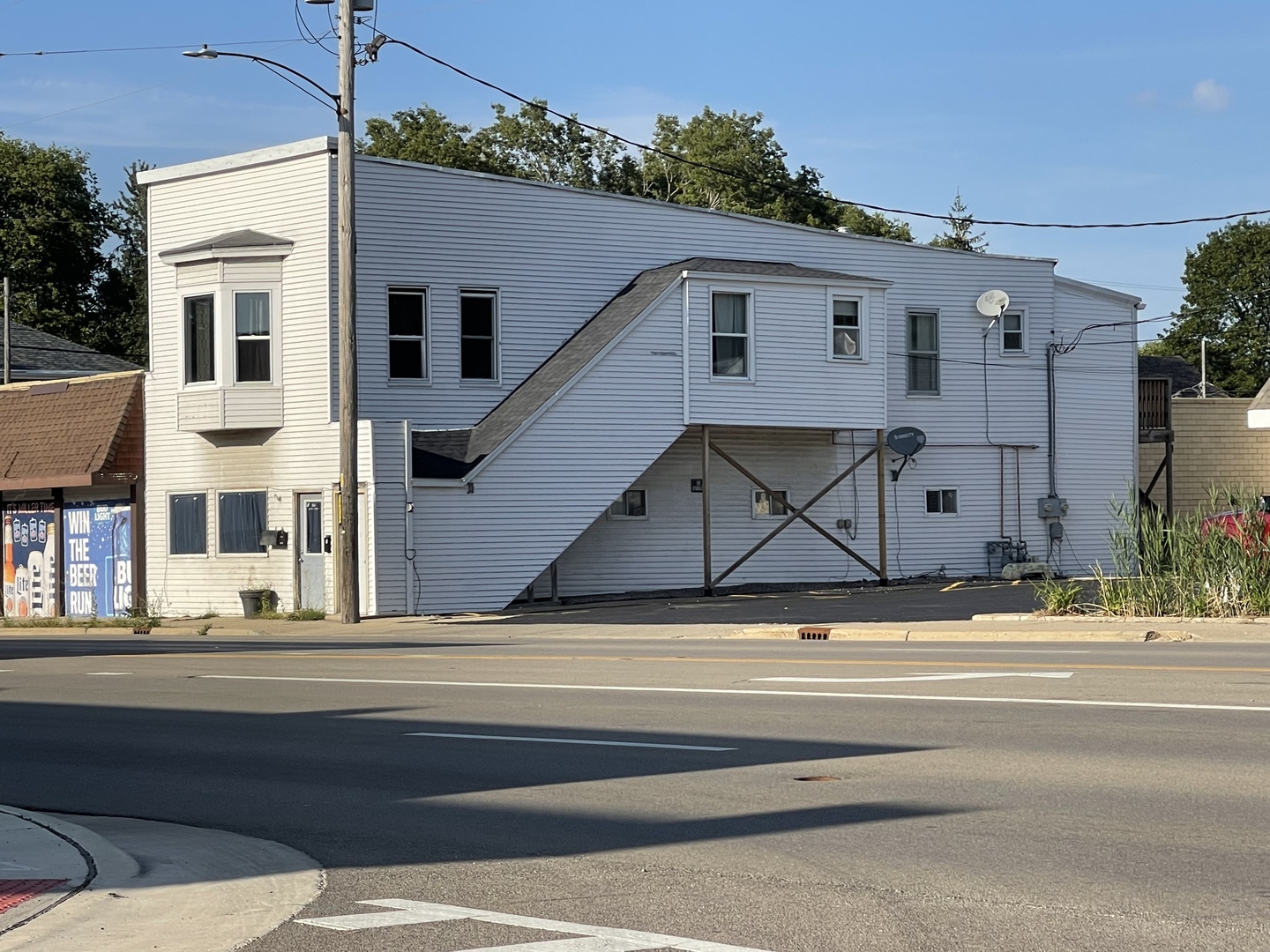 a view of street along with house and car parked