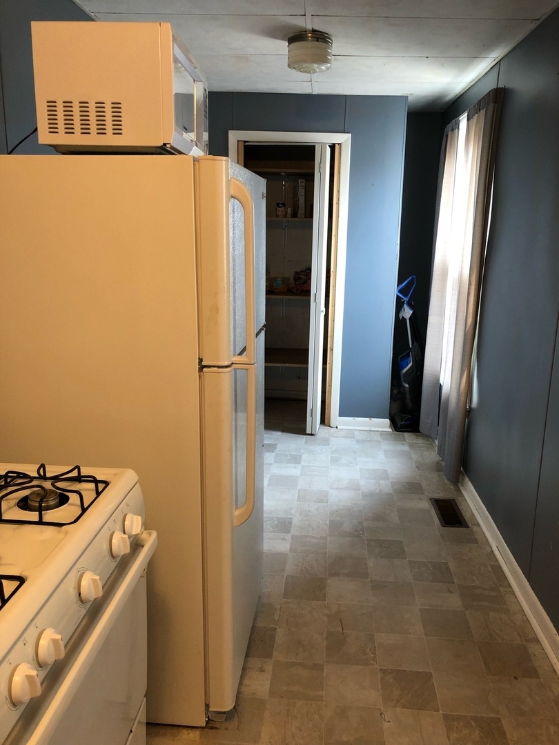 504 State Street Ottawa, IL 61350 - Photo 15 of 19 a view of storage and utility room with refrigerator and washer