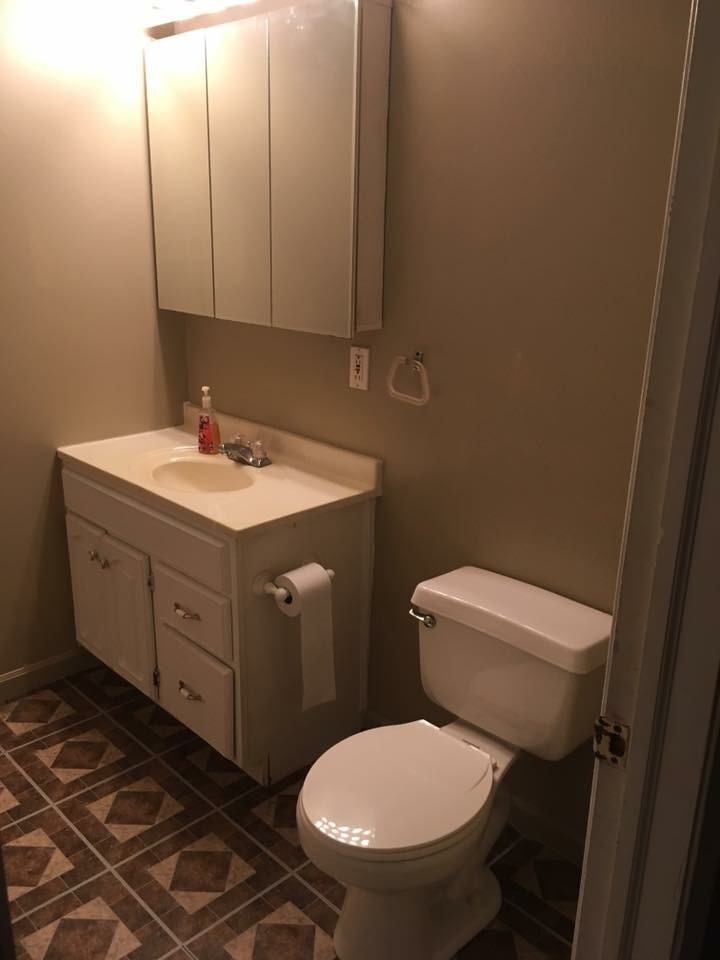 504 State Street Ottawa, IL 61350 - Photo 4 of 19 a bathroom with a toilet sink and mirror